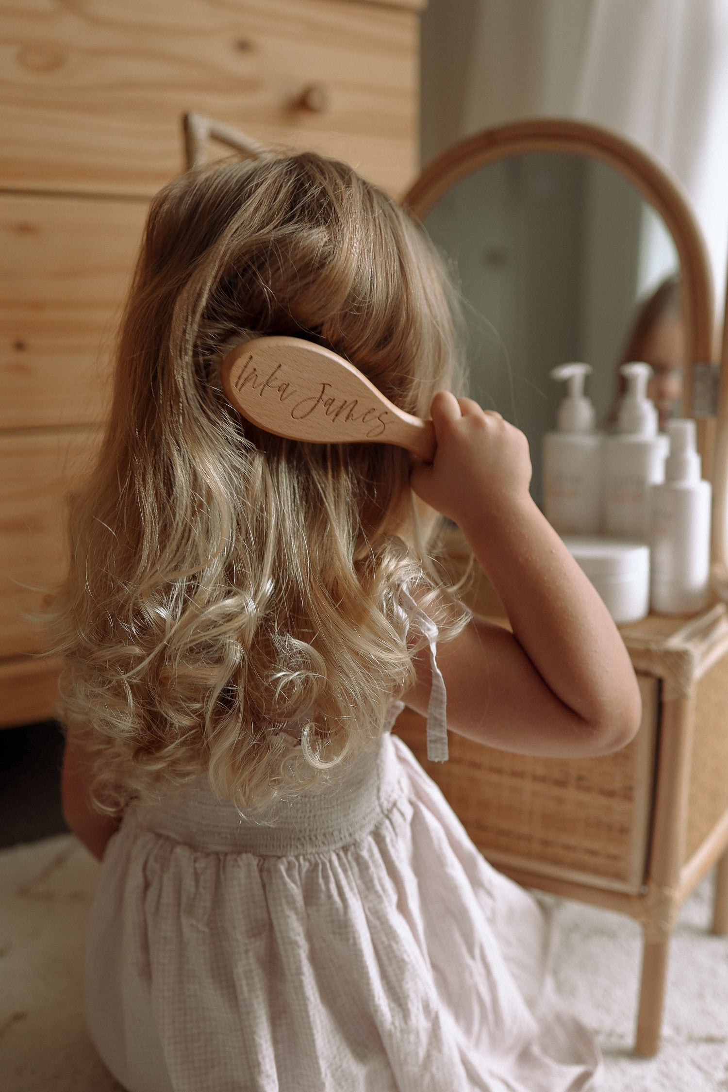 Little Lane curly girl brushing her hair