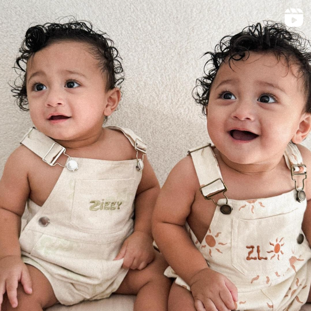two babies with curly hair